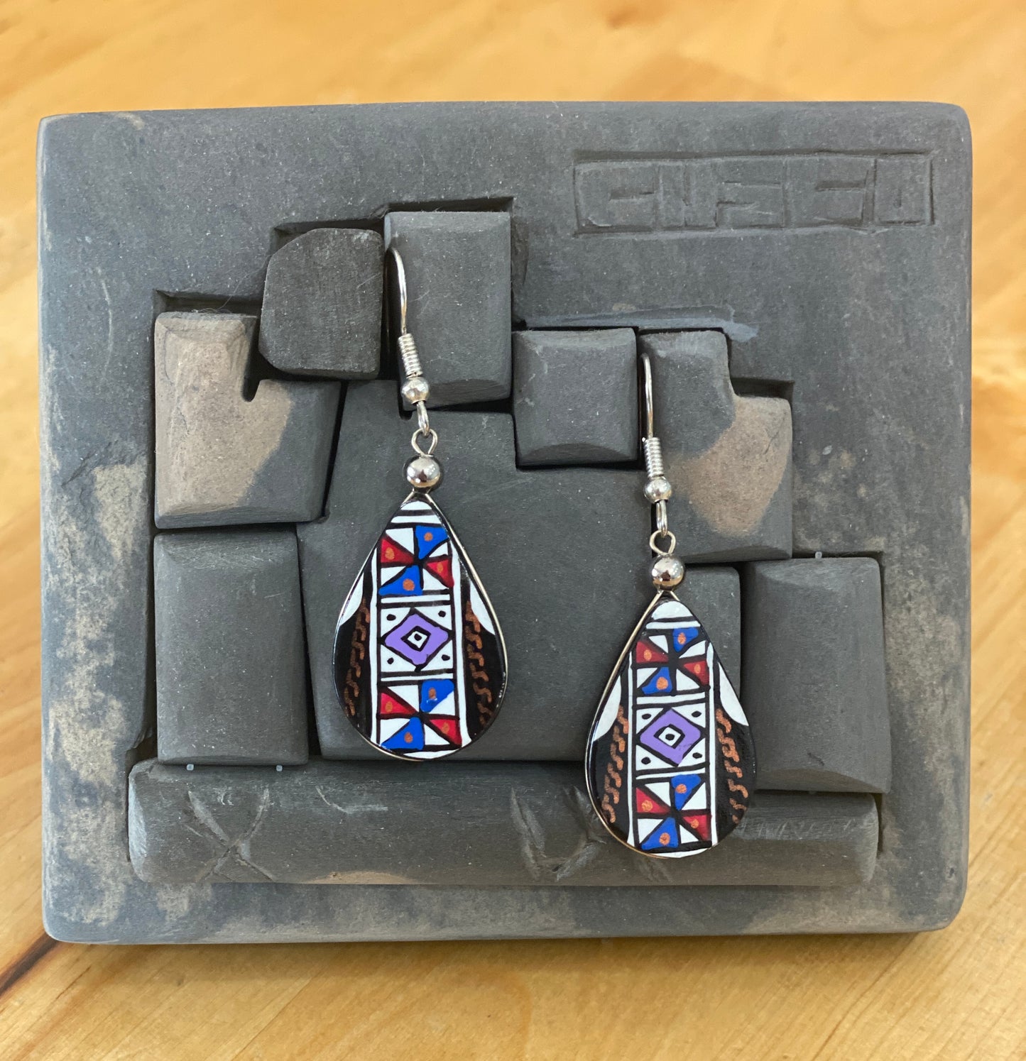 Hand painted wooden tear drop shaped dangle earrings. Authentic hand painted Inka symbols dangle earrings. Sterling Silver Hooks Available.