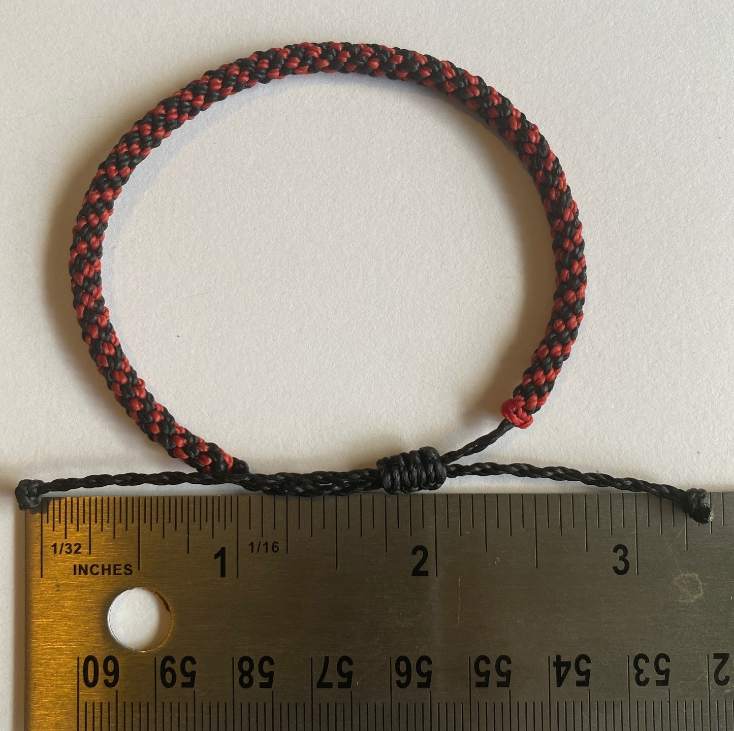 Hand braided nylon cord adjustable bracelet.