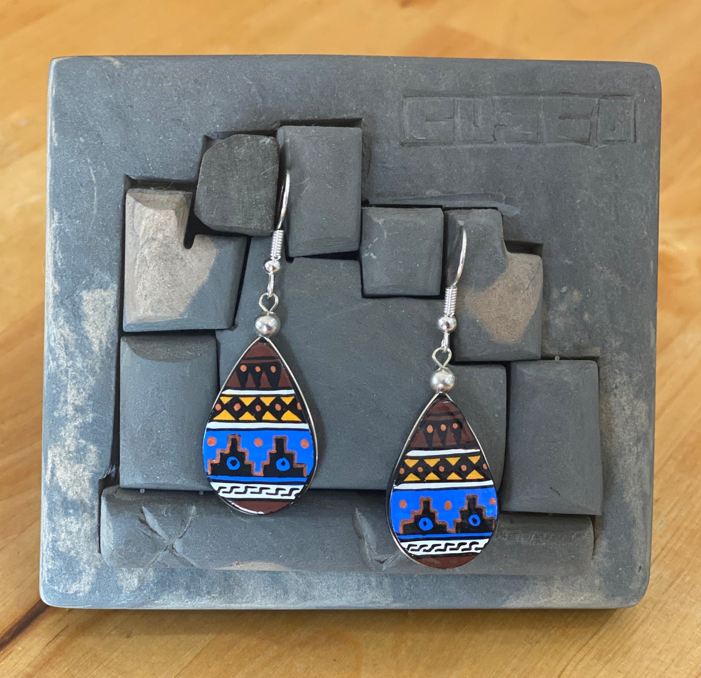 Hand painted wooden tear drop shaped dangle earrings. Authentic hand painted Inka symbols dangle earrings. Sterling Silver Hooks Available.